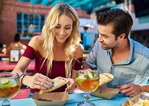 Couple enjoying tacos at a restaurant