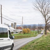Van on Road with Country Views