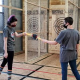 Two People Touching Axes Together