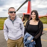 Couple in front of helicopter