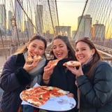 Girls eating pizza on bridge