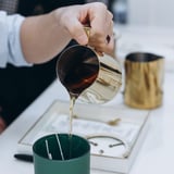 Person pouring wax into mold