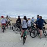 Group riding bikes on beach