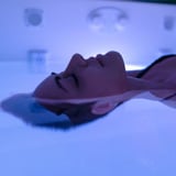 Person relaxing in float tank