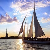 Boat at sunset near Statue of Liberty