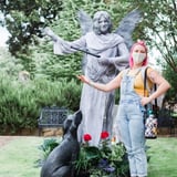 Woman posing with statue