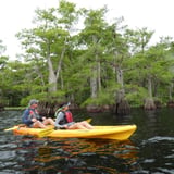 Two people kayaking on lake