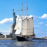 Ship in front of Statue of Liberty