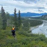 Person Zip Lining through Mountains