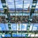 People Standing on Glass Above City