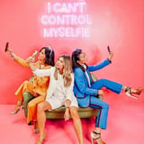 Group Posing with Phones in Pink Room