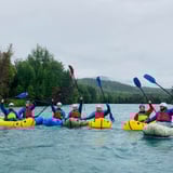 Group Posing in Water with Paddles Up