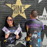 Two people in Prince merchandise