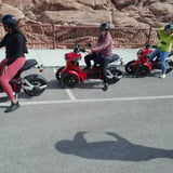 People riding scooters