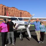 Group in Front of Plane and Rock