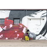 Couple posing in front of wall art