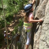 Little girl climbing rock