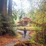 Woman Hiking Towards Structure 