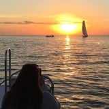 Person on Boat Looking at Sunset