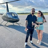 Couple Standing in Front of Helicopter 
