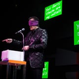 Man blindfolded with screens behind