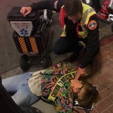 Woman Lying on Ground with Paramedic 