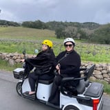 Two people riding trike through countryside