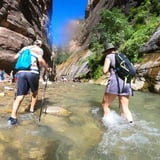 Two people hiking in water