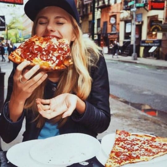 Woman eating pizza