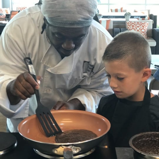 Chef helping kid