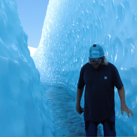 Man Walking Through Ice Cave