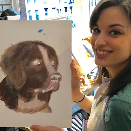 Girl Holding up Completed Dog Painting 