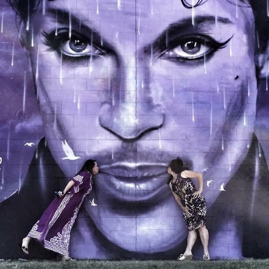 Two people kissing prince mural
