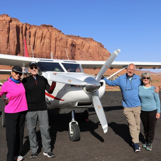 Group in Front of Plane and Rock