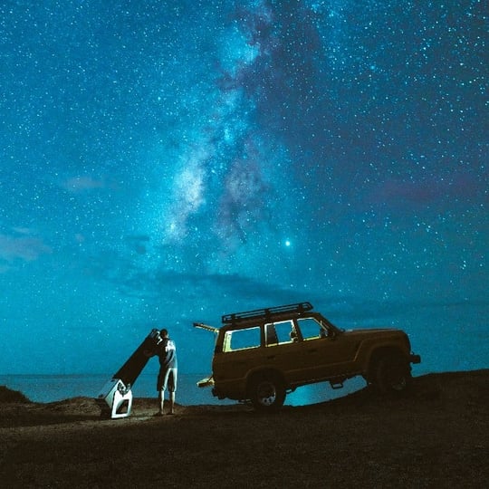 Car on Cliff with Blue Star Filled Sky