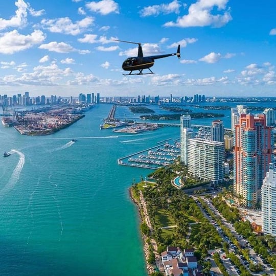 Helicopter Above Water and City