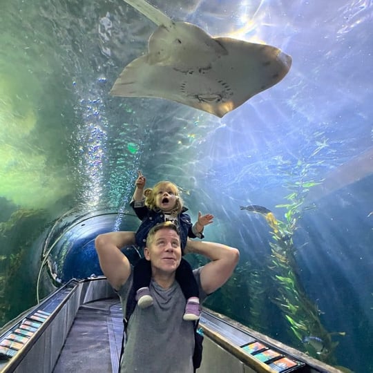 Father and child below sting ray