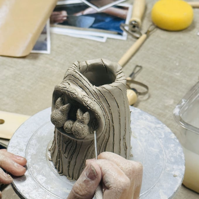 Person sculpting clay