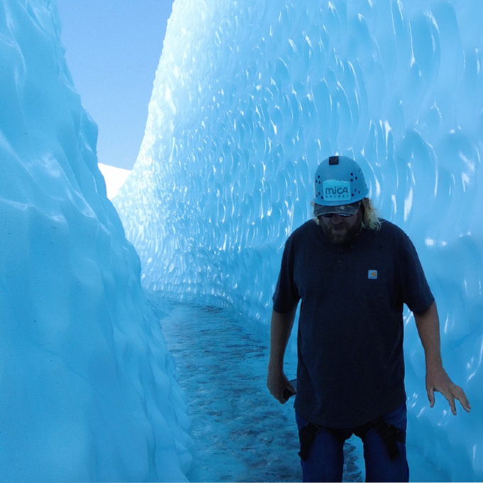 Man Walking Through Ice Cave