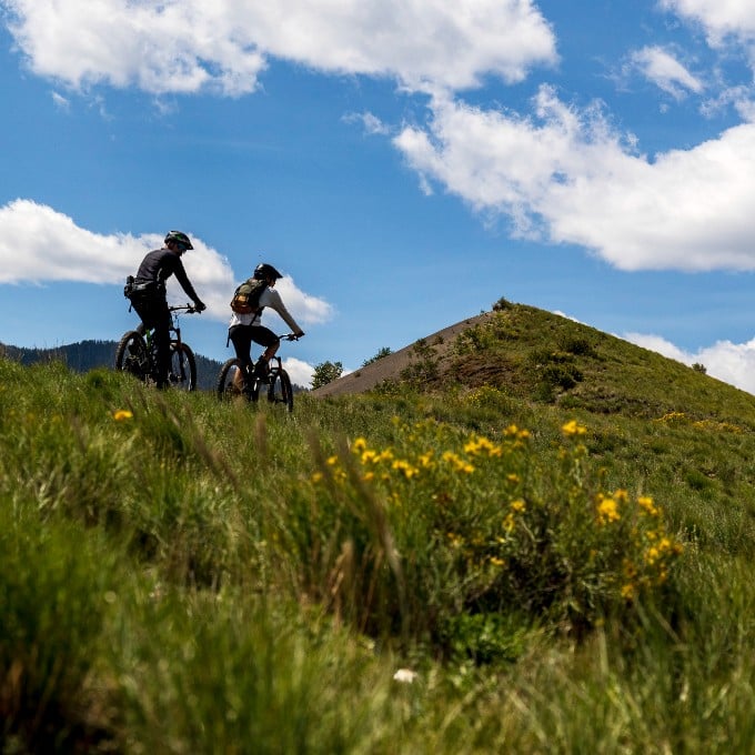 Two people riding on mountain