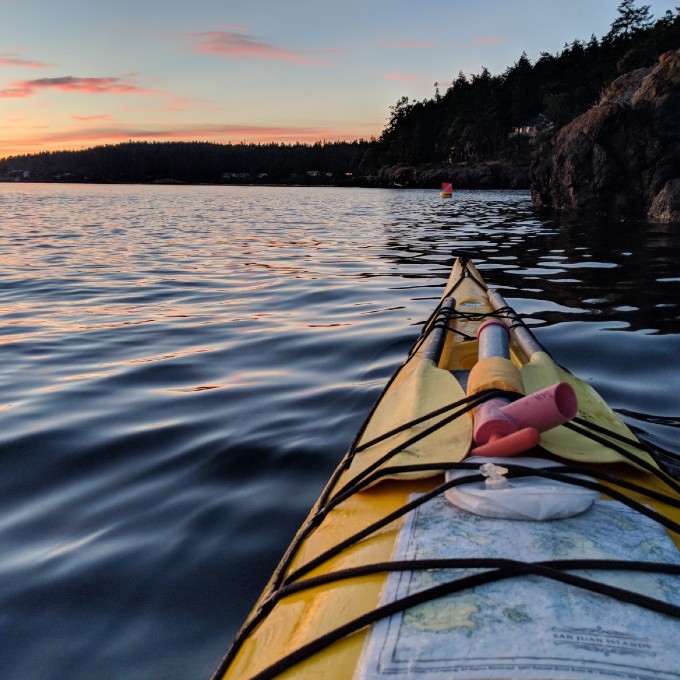 Kayak on water at sunset