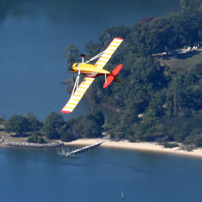 Plane in air over water