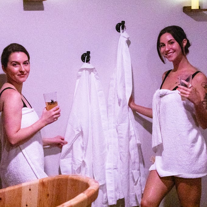 Two woman in towels with drinks