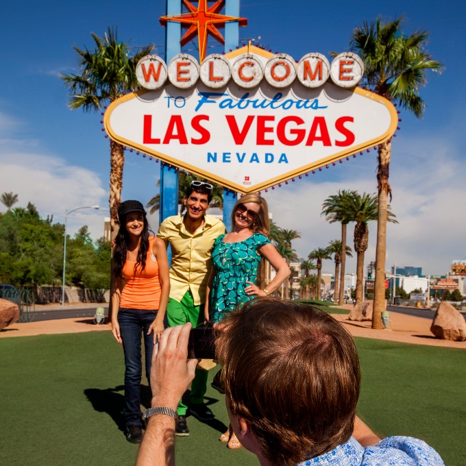 People in front of Las Vegas sign