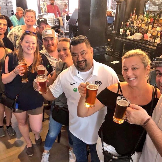 Group posing with beers