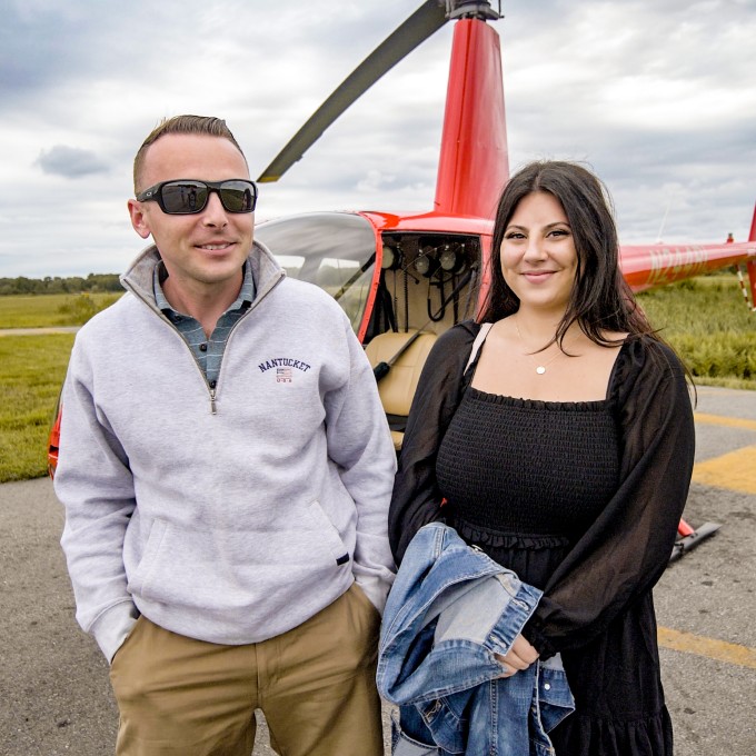 Couple in front of helicopter