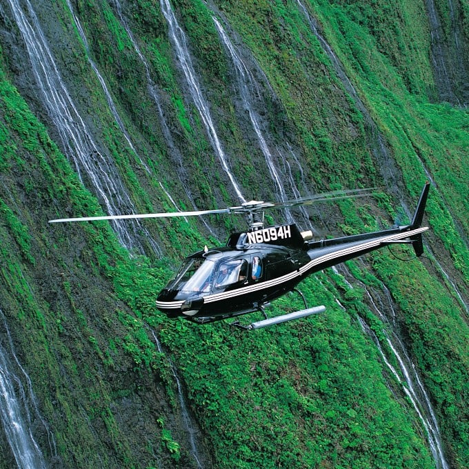 Helicopter flying near waterfalls