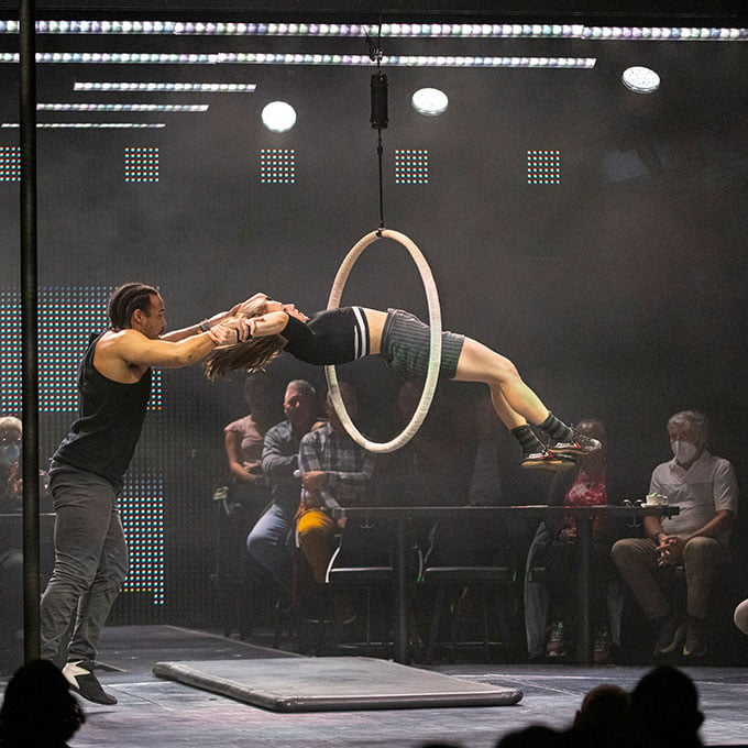 Performer jumping through hoop