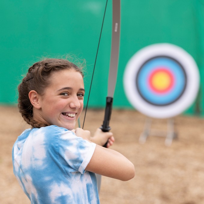 Girl shooting bow and arrow