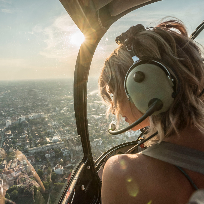 Woman in helicopter at sunset